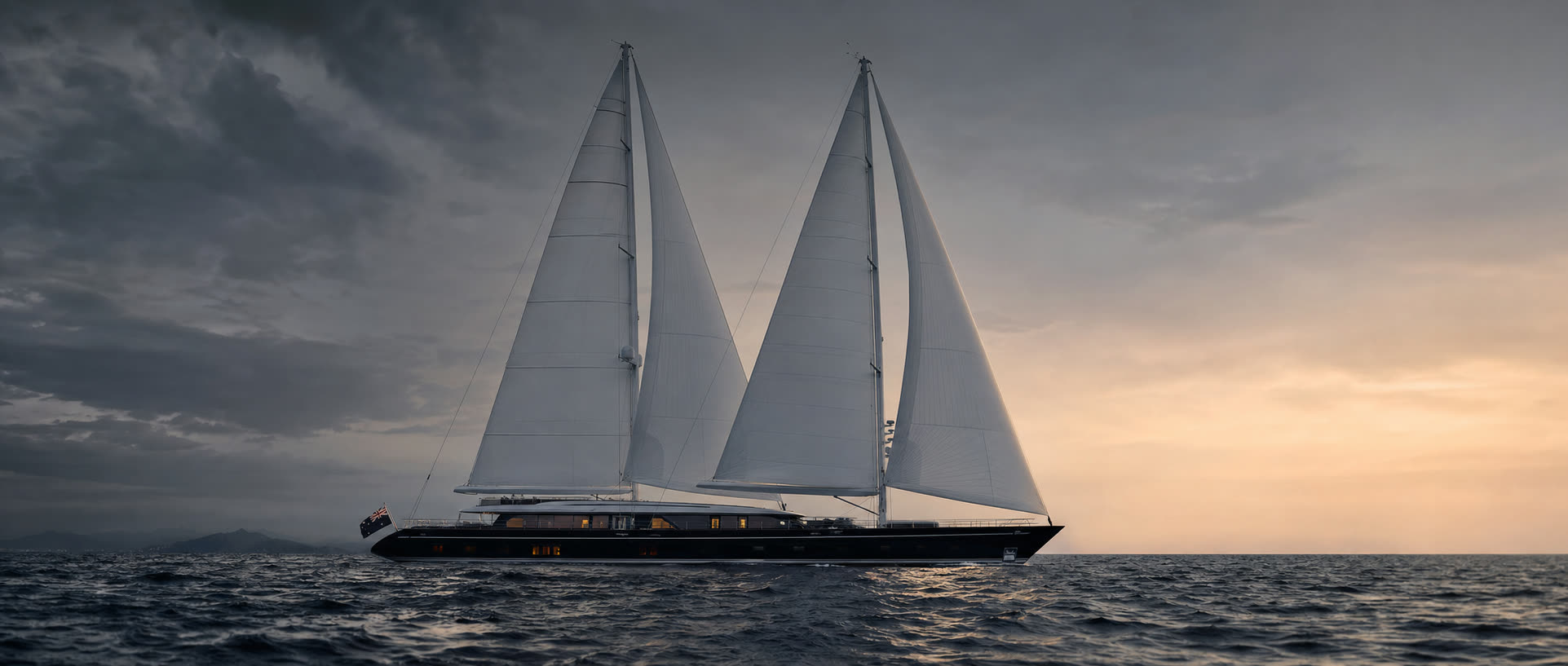 Perini Navi sailing superyacht under full sail at dusk